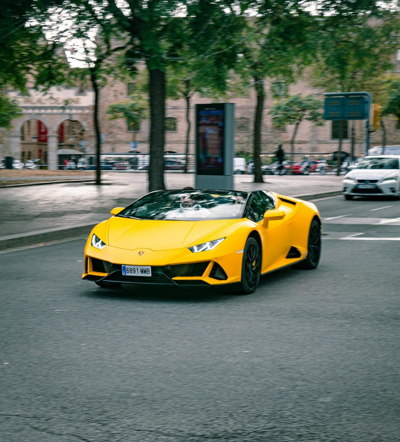 Red Lamborghini Huracan parked front Burj Khalifa Dubai supercar rental